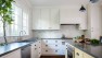 Kitchen Remodel with Classic Charm – Madrona Kitchen – Board & Vellum – Painted white and yellow cabinets.