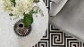 Interior design services at Board & Vellum. - Detail of a table, chair, and carpet from above.