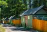 The new Dog Towne at Pasado’s Safe Haven is situated along an unpaved lane. They look like a row of small cabins with a high wooden fence to protect the dogs.