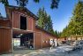 The old barn at Pasado’s Safe Haven is brown with large doors open, revealing a storage loft and ground floor storage space and animal housing.